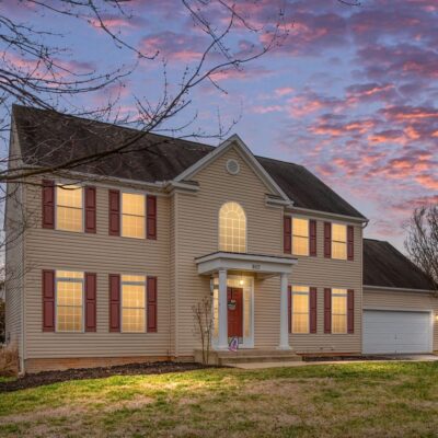 Two story home in Culpeper VA, lighted windows with sunset skies.