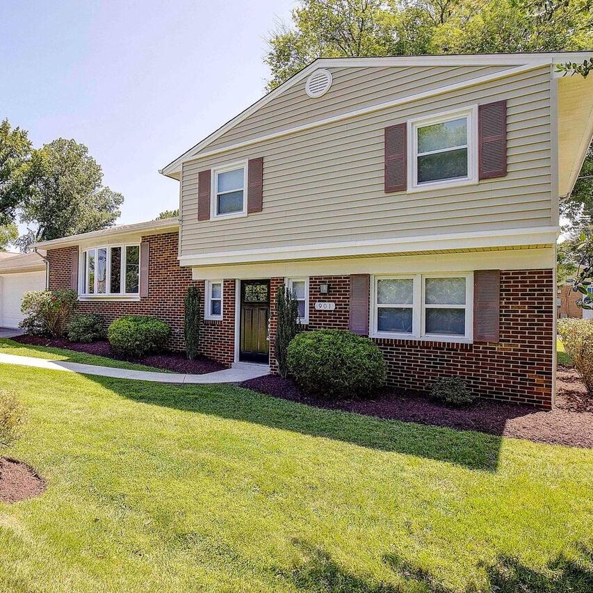 Front view of brick and cream siding home of a first time home buyer.