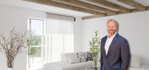 Derek Harman standing in living room