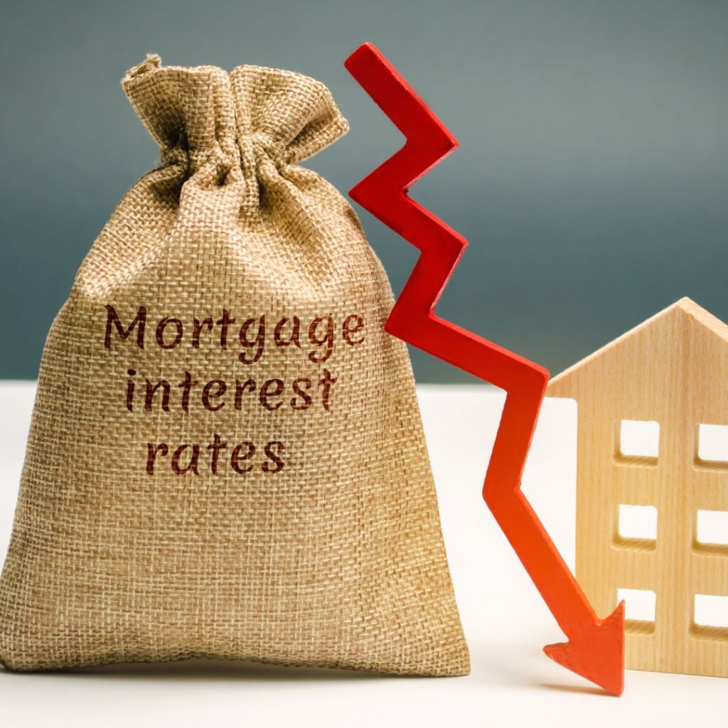 Bag labeled mortgage interest rates with dropping red arrow showing spring real estate market