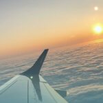 Travel Nurses Overcoming Home Loan Hurdles. View of setting sun over airplane wing.