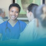 Travel Nurse looking at others with a smile, discussing short employment history