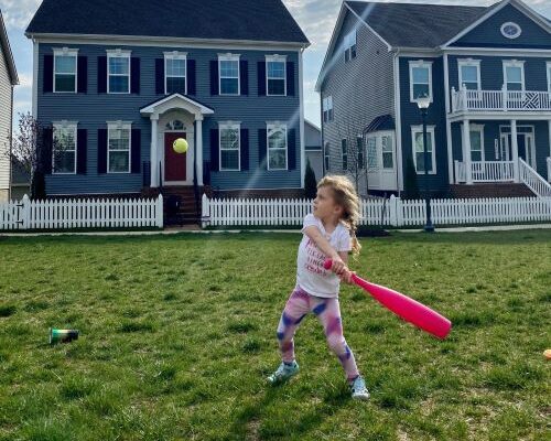 Child of millennials, playing baseball in new home community.