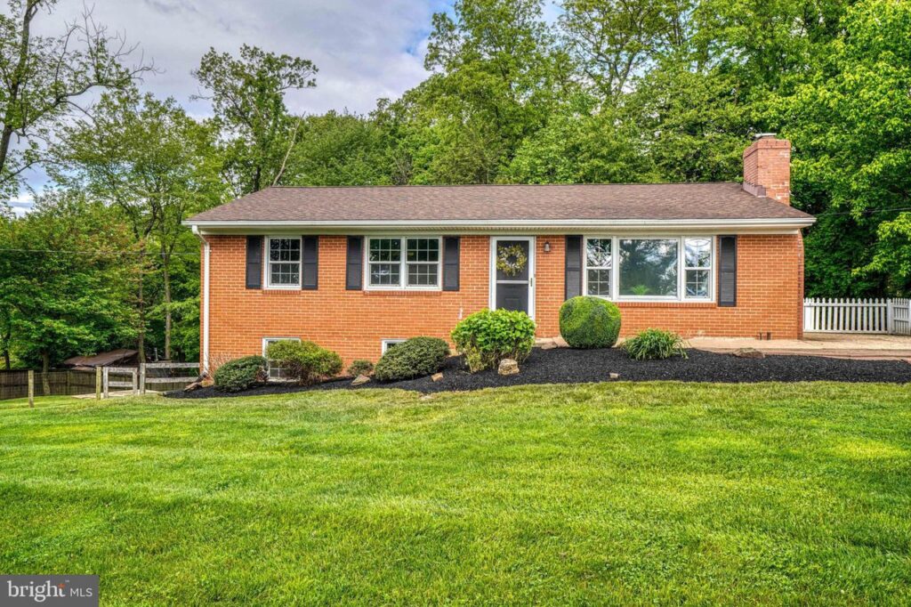 Brick home in green grass yard