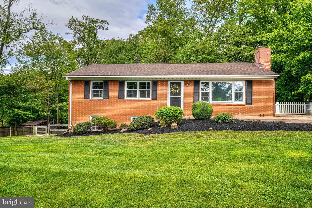 Brick home in green grass yard